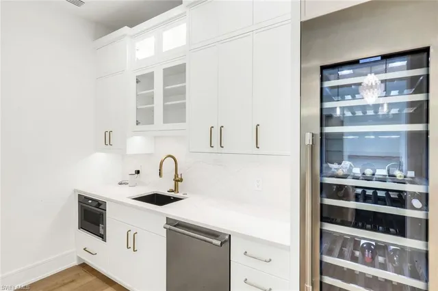 a kitchen with stainless steel appliances a sink a stove and a refrigerator
