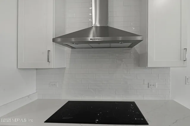 a view of a sink a mirror and cabinets