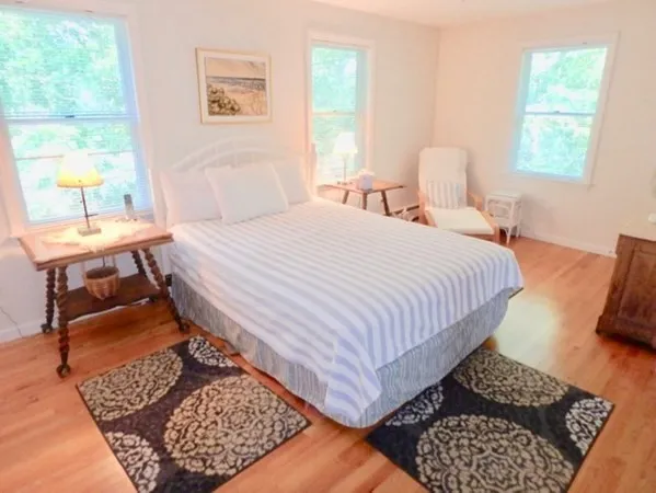 a bedroom with a bed rug and window