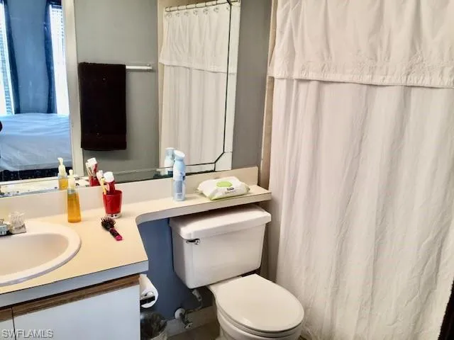 a bedroom with a bed a desk and a window