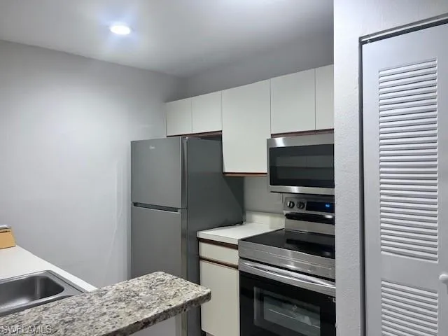 a kitchen with a refrigerator stove and microwave