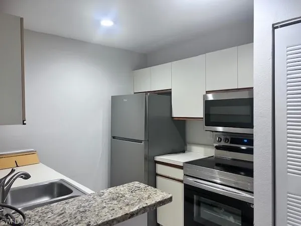 a kitchen with a appliances and cabinets
