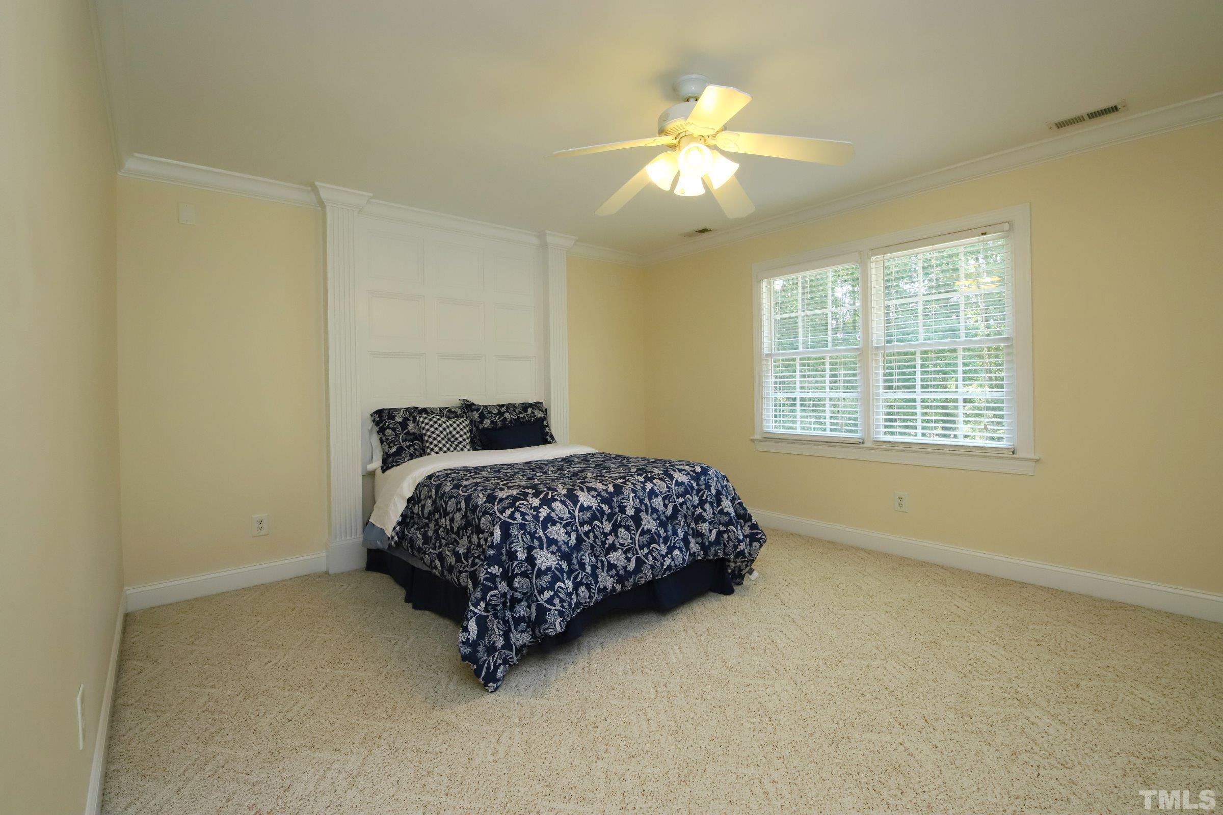 4925 Torry Ridge Road Raleigh, NC 27613 - Photo 22 of 30 a bedroom with a bed and a chandelier