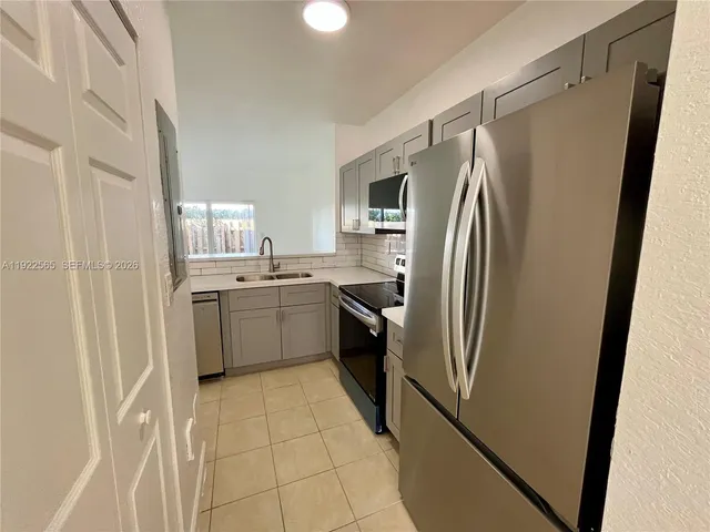 a kitchen with stainless steel appliances a refrigerator and a sink