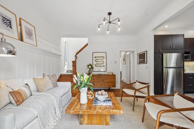 a living room with furniture and kitchen view