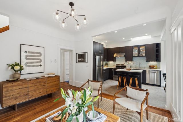 a kitchen with a table chairs refrigerator and cabinets