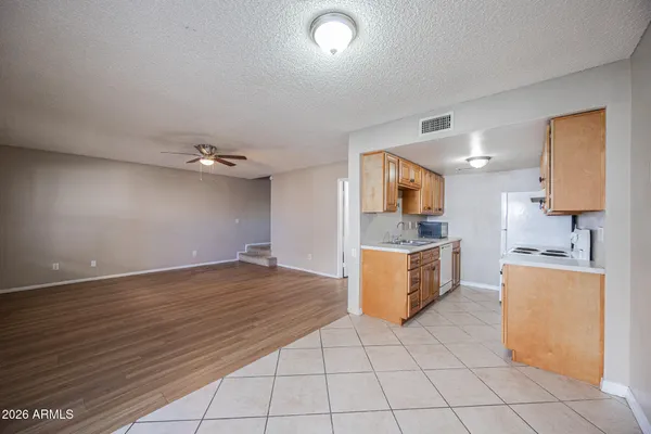 a large kitchen with kitchen island granite countertop a sink and a stove top oven