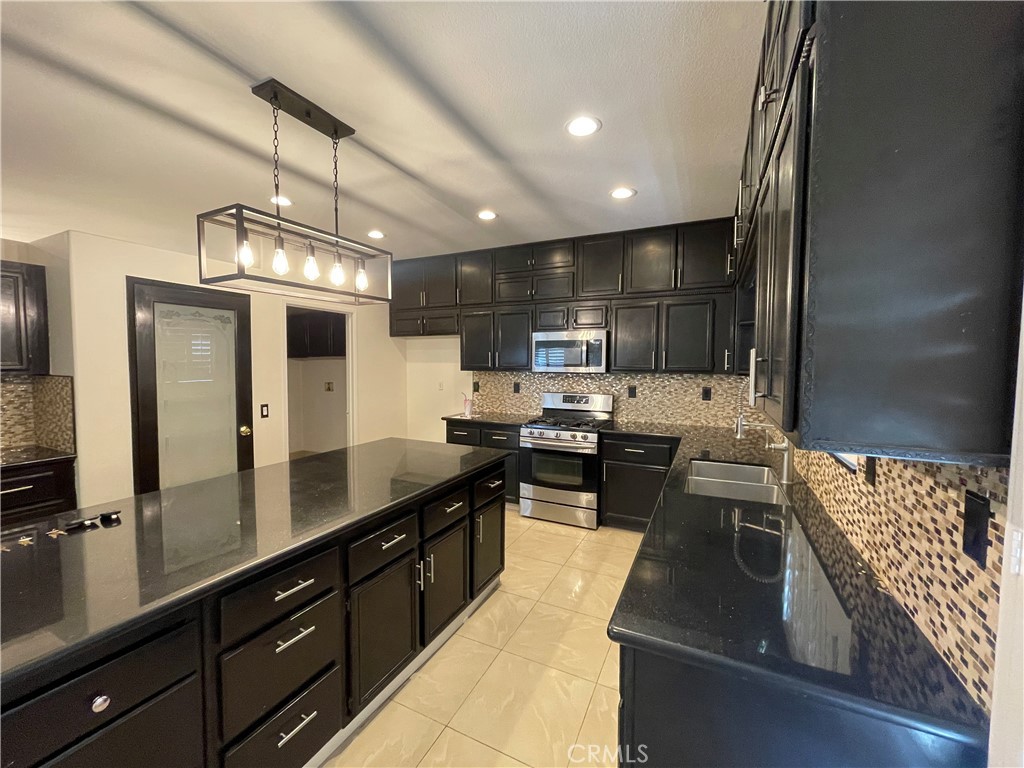 83107 Greenbrier Drive Indio, CA 92203 - Photo 1 of 29 a kitchen with stainless steel appliances granite countertop a sink stove and refrigerator