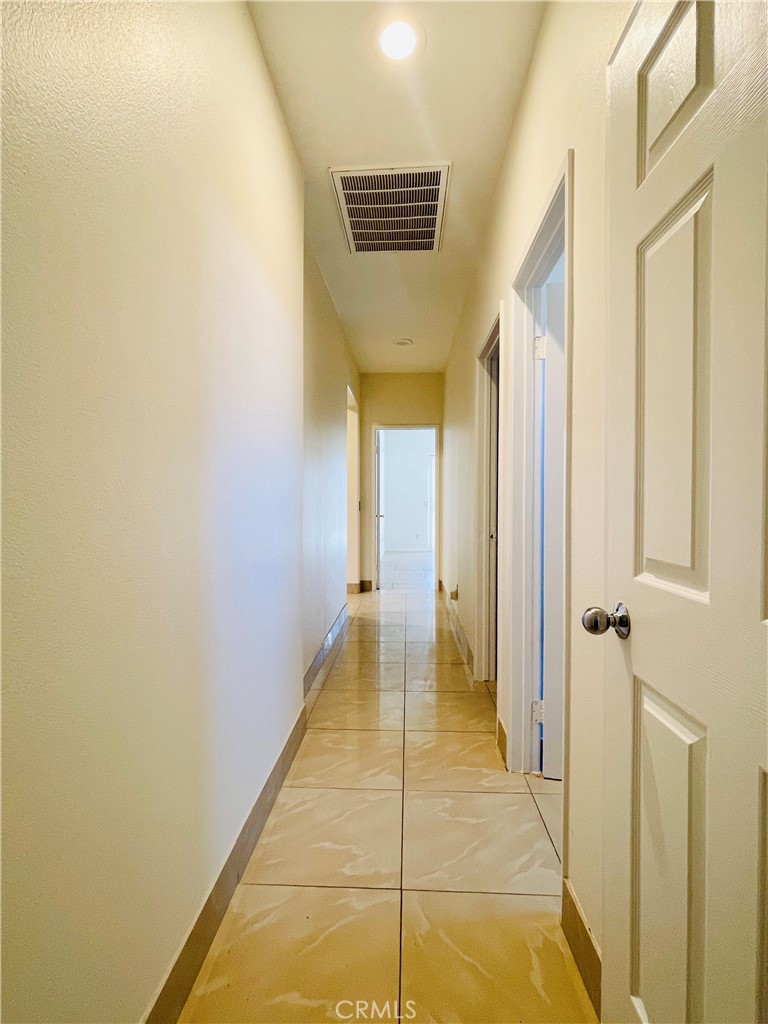 83107 Greenbrier Drive Indio, CA 92203 - Photo 13 of 29 a view of a hallway with wooden floor and a bathroom
