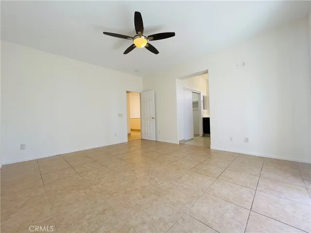 a view of a livingroom with a ceiling fan and window