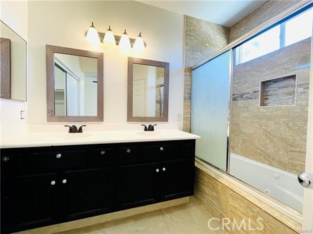 83107 Greenbrier Drive Indio, CA 92203 - Photo 17 of 29 a bathroom with a double vanity sink mirror and bathtub