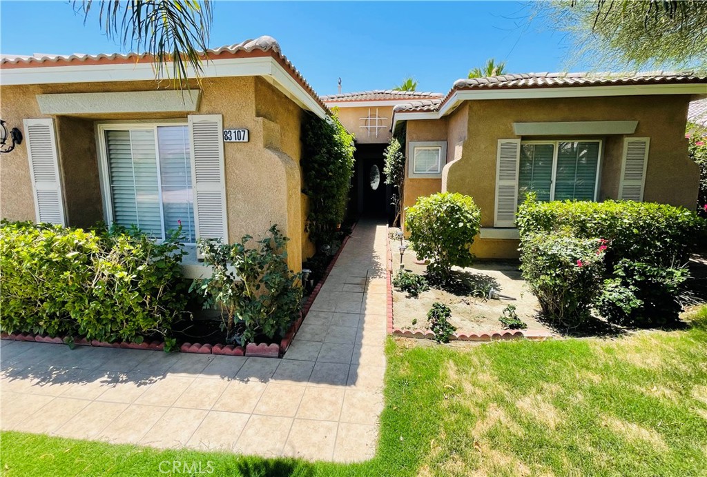 83107 Greenbrier Drive Indio, CA 92203 - Photo 5 of 29 a front view of a house with a yard