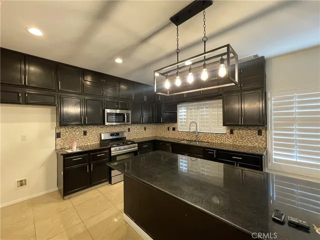 a kitchen with lots of counter space and stainless steel appliances