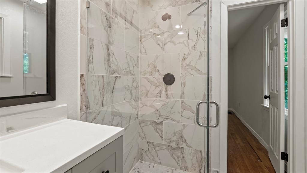4600 Robinwood Drive Waco, TX 76708 - Photo 21 of 24 a bathroom with a sink vanity and shower