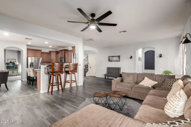 a living room with furniture and kitchen view
