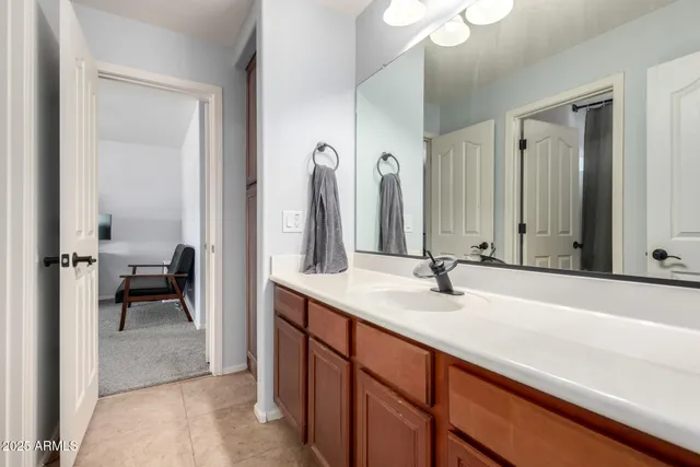 a en suite bathroom with a sink and a mirror