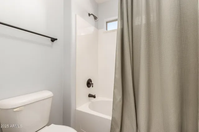 a bathroom with a toilet and a bathtub