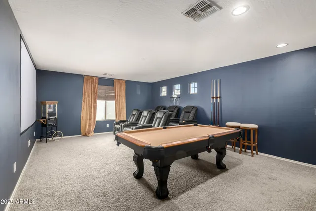 a room with furniture pool table and windows