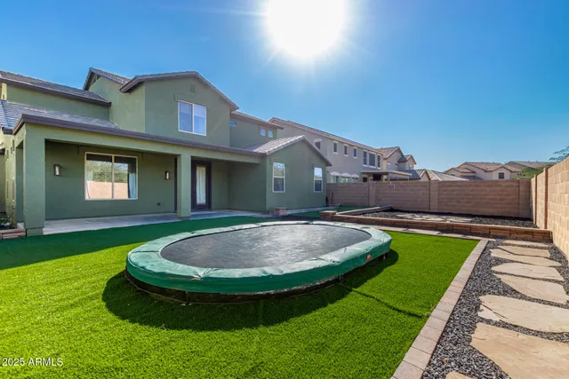 a view of a house with a swimming pool and a yard