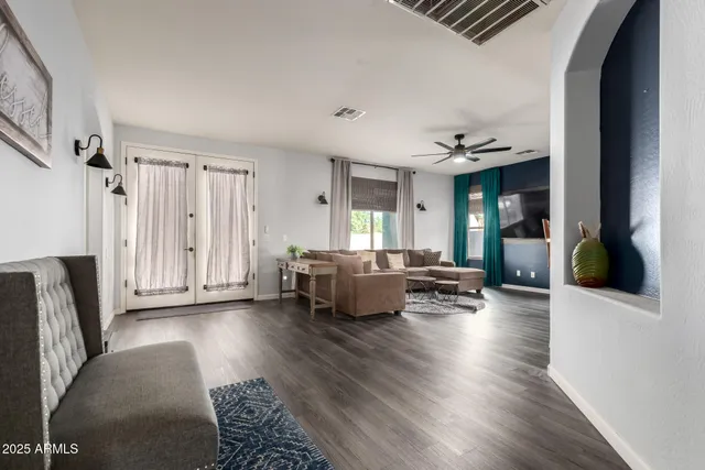 a living room with furniture and a wooden floor