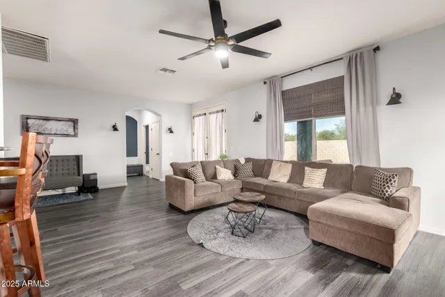 a living room with furniture and a wooden floor