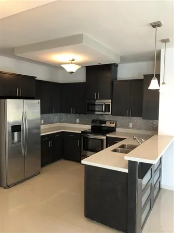 a kitchen with a sink a stove and refrigerator