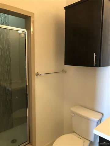 a white toilet sitting next to a bathroom sink