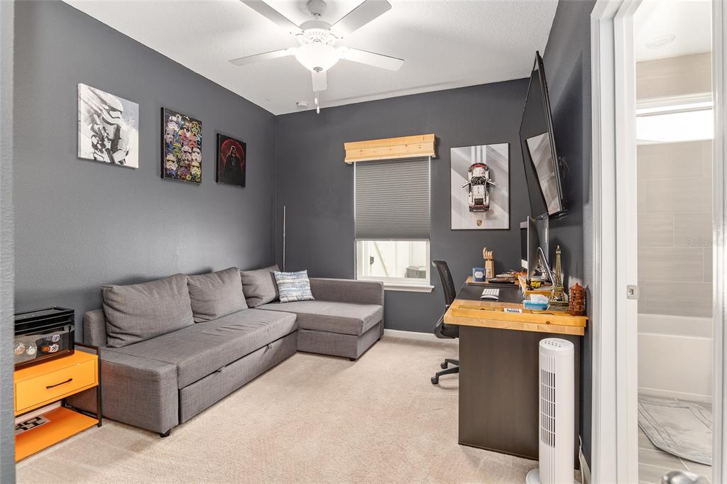 5688 Southwest 92nd Place Ocala, FL 34476 - Photo 40 of 54 a living room with furniture and a flat screen tv