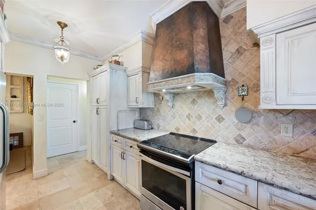 a kitchen with stainless steel appliances granite countertop a refrigerator and a microwave