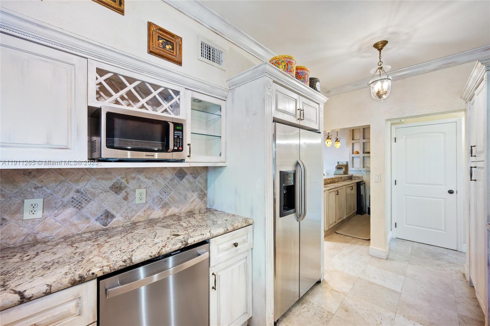 3308 Northeast 16th Place Fort Lauderdale, FL 33305 - Photo 13 of 31 a kitchen with stainless steel appliances granite countertop a refrigerator and a microwave