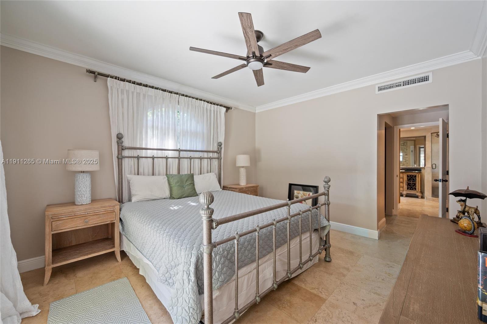 3308 Northeast 16th Place Fort Lauderdale, FL 33305 - Photo 16 of 31 a bedroom with a bed and a chandelier