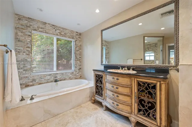 a bedroom with two beds and ceiling fan