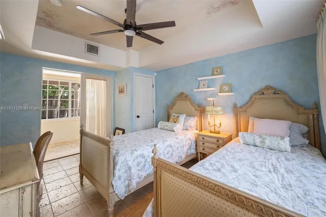 a bedroom with a bed and ceiling fan