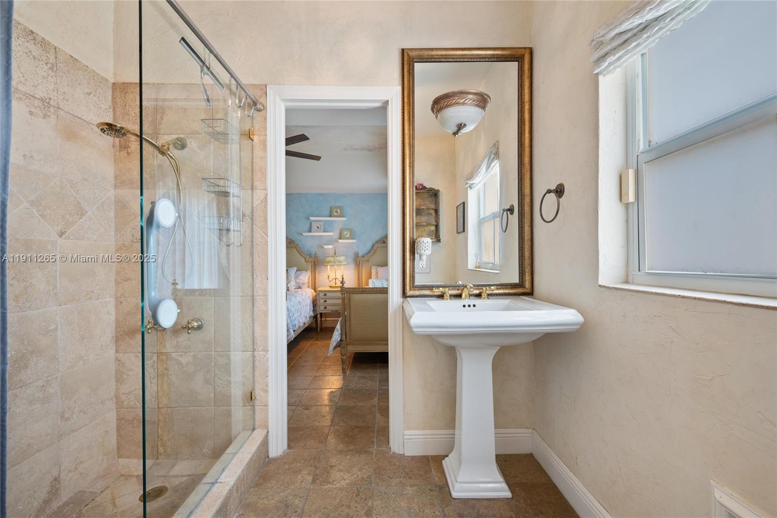 3308 Northeast 16th Place Fort Lauderdale, FL 33305 - Photo 22 of 31 a bathroom with a sink a mirror a bathtub and shower