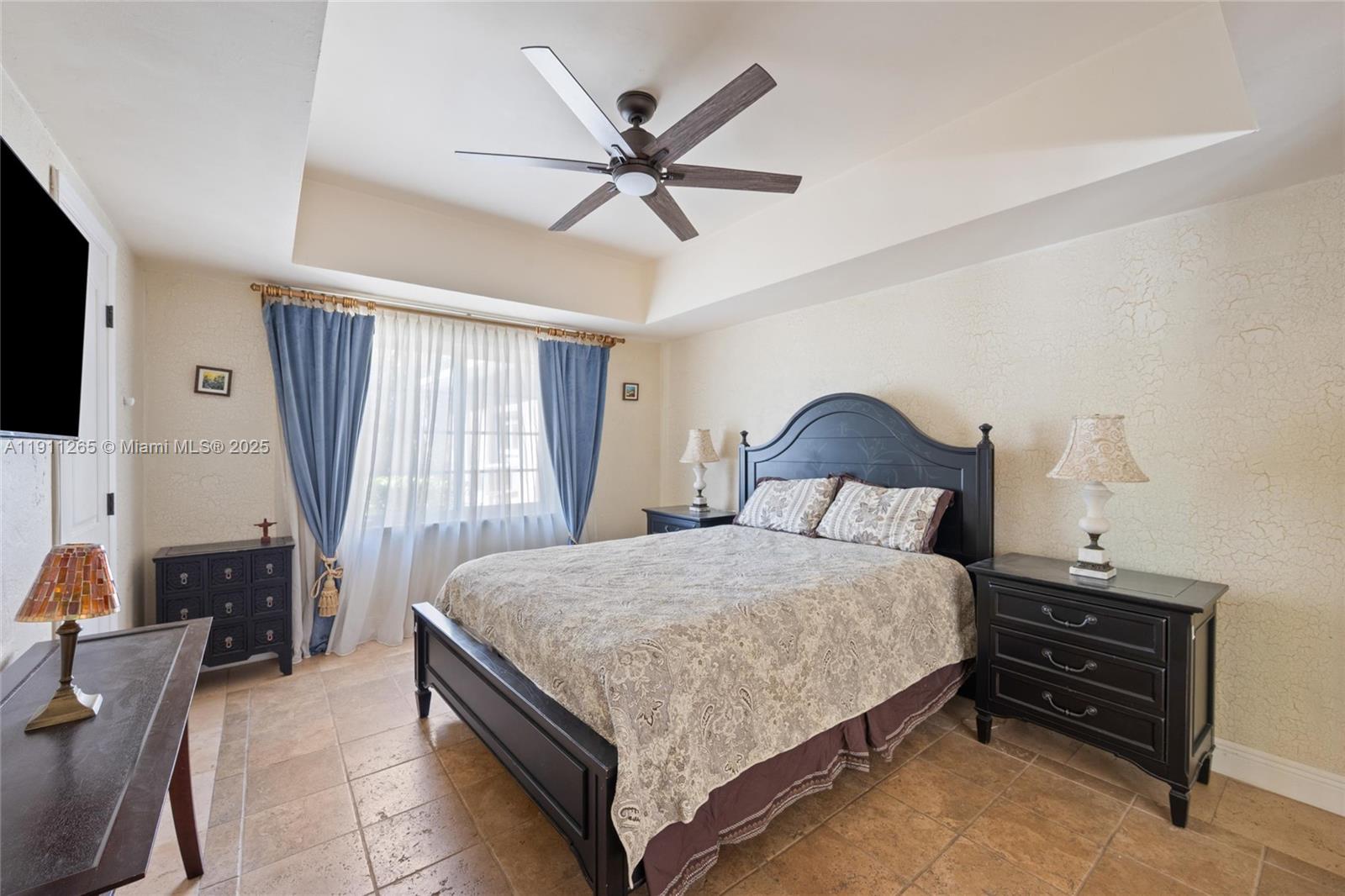 3308 Northeast 16th Place Fort Lauderdale, FL 33305 - Photo 23 of 31 a bedroom with a bed and a chandelier