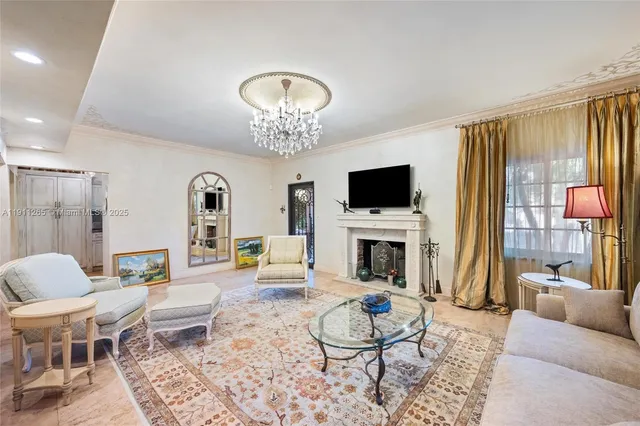 a living room with furniture and a chandelier