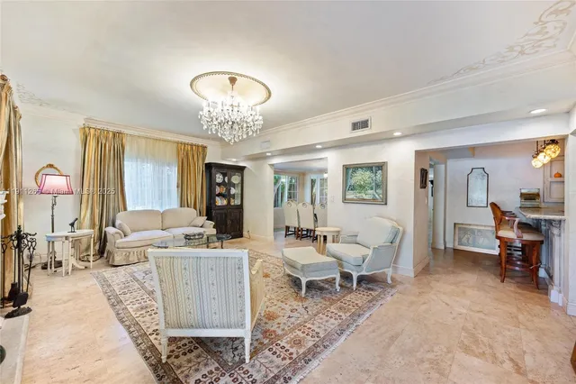 a living room with furniture a window and a flat screen tv