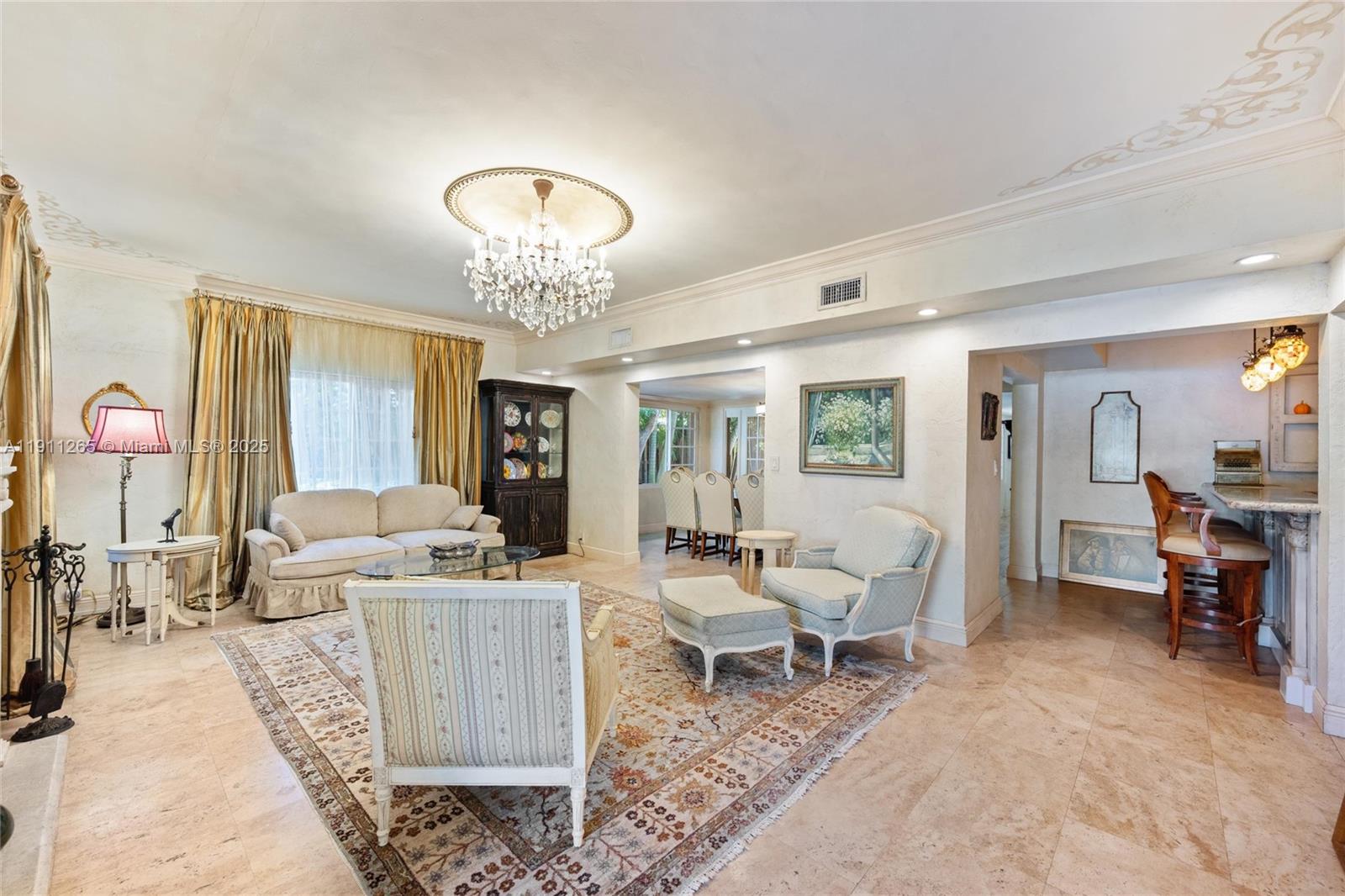 3308 Northeast 16th Place Fort Lauderdale, FL 33305 - Photo 7 of 31 a living room with furniture and a chandelier
