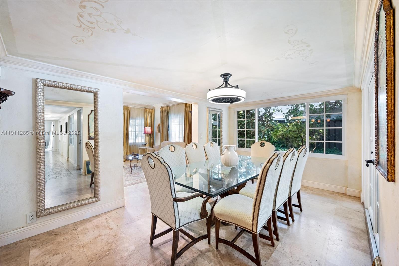 3308 Northeast 16th Place Fort Lauderdale, FL 33305 - Photo 10 of 31 a view of a dining room with furniture wooden floor and chandelier