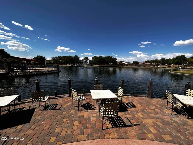 a lake view with tables and chairs