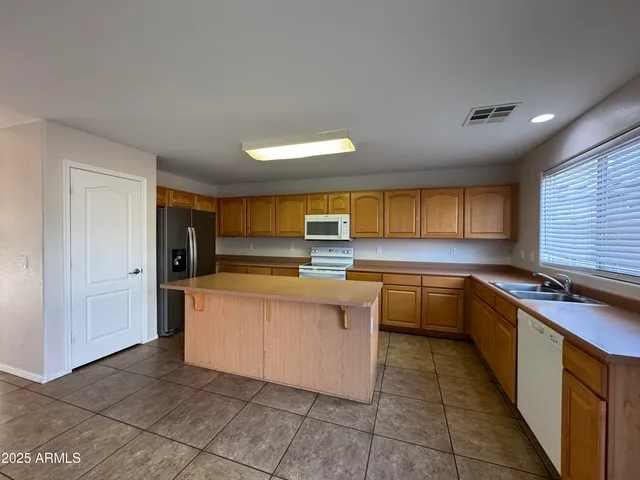 a kitchen with stainless steel appliances granite countertop a sink and cabinets