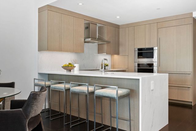 a kitchen with a sink cabinets and appliances