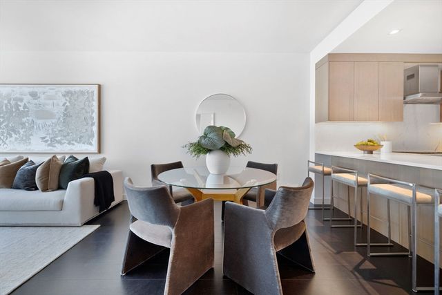 a living room with furniture and a dining table