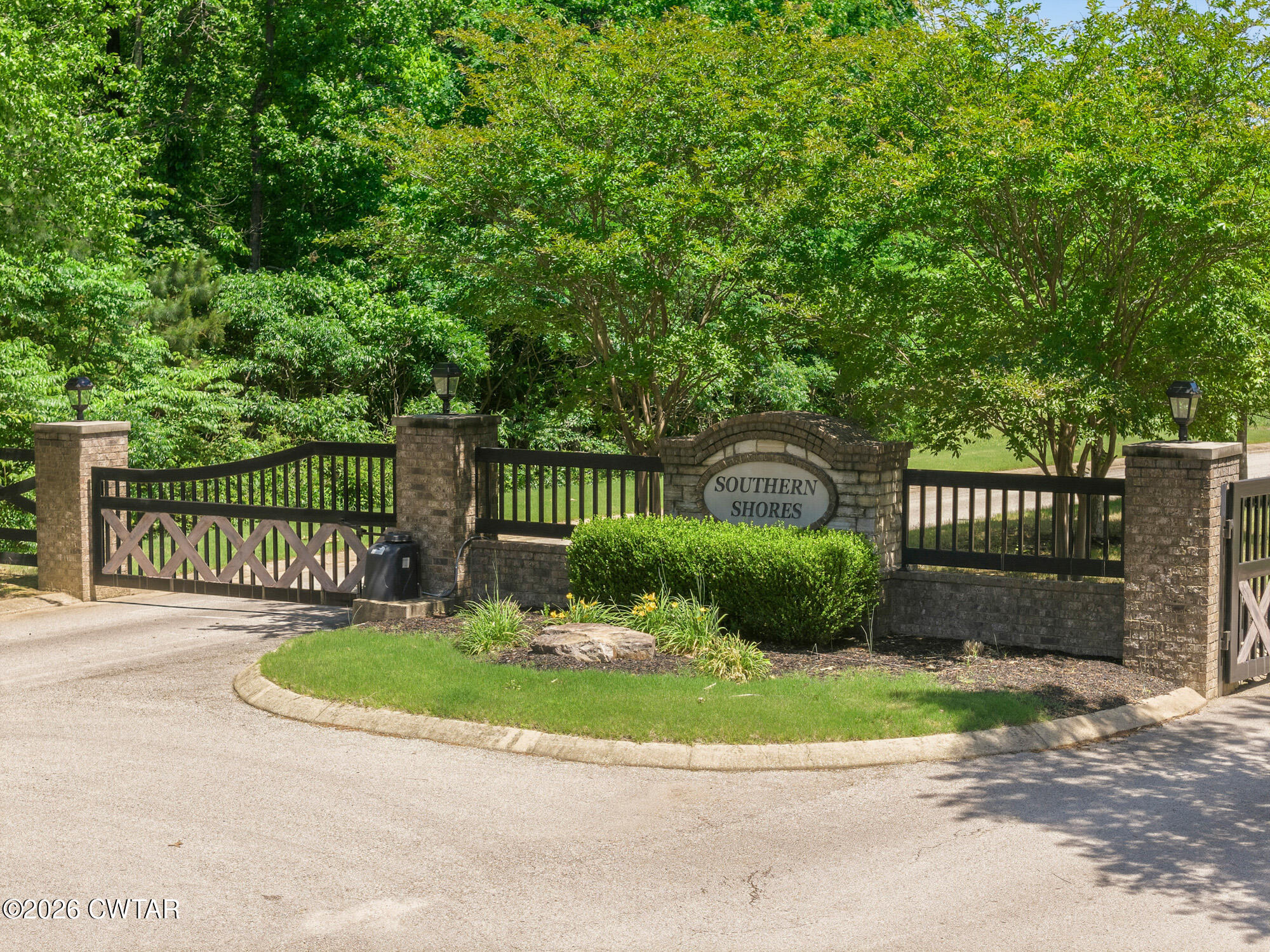 Lot 118 Kyle Road Huntingdon, TN 38344 - Photo 6 of 16 a view of a house with a small yard plants and large trees