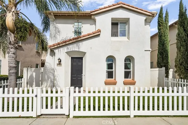 a front view of a house with a fence