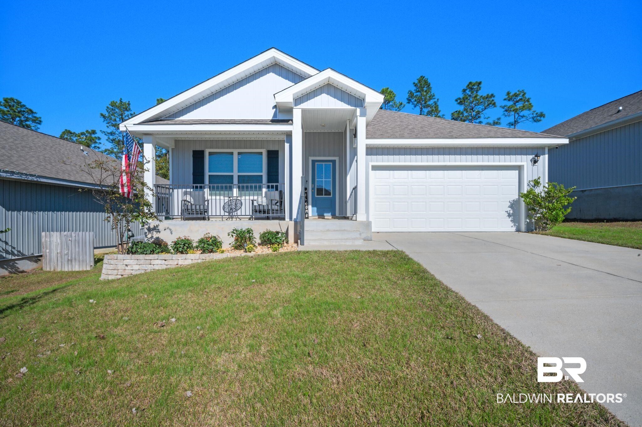 10306 Brodick Loop Spanish Fort, AL 36527 - Photo 1 of 35 View of front facade featuring covered porch, a garage, and a front lawn
