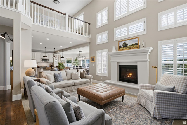 1257 Rigby Road Kaysville, UT 84037 - Photo 10 of 55 Two-story living area with hardwood flooring, a fireplace with a substantial mantel, and multiple windows with plantation shutters