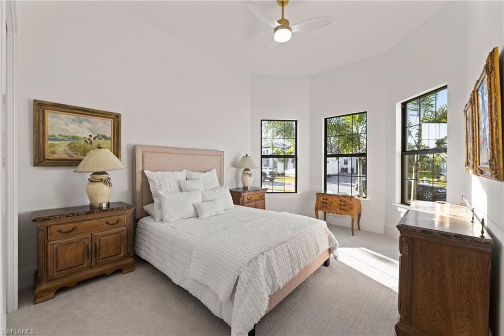16140 Verilyn Circle Naples, FL 34110 - Photo 18 of 44 a bedroom with a large bed and a window