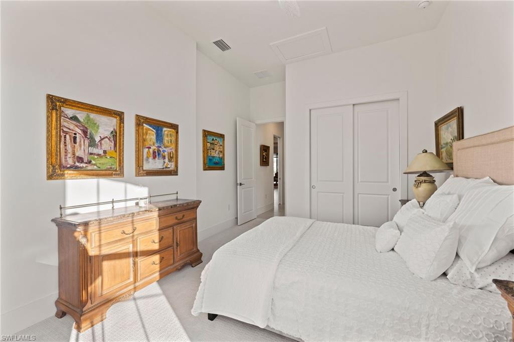 16140 Verilyn Circle Naples, FL 34110 - Photo 19 of 44 a bedroom with a bed and a painting on the wall