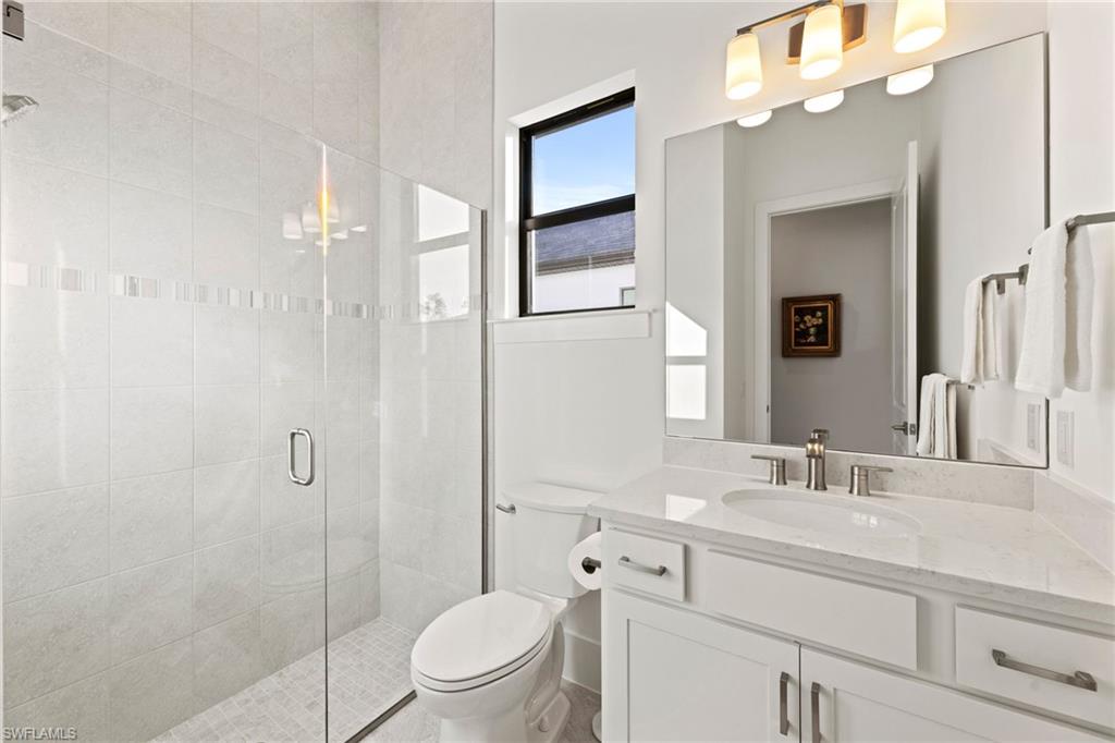 16140 Verilyn Circle Naples, FL 34110 - Photo 20 of 44 a bathroom with a sink a toilet and shower